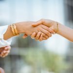 Businesswomen shaking hands outdoors